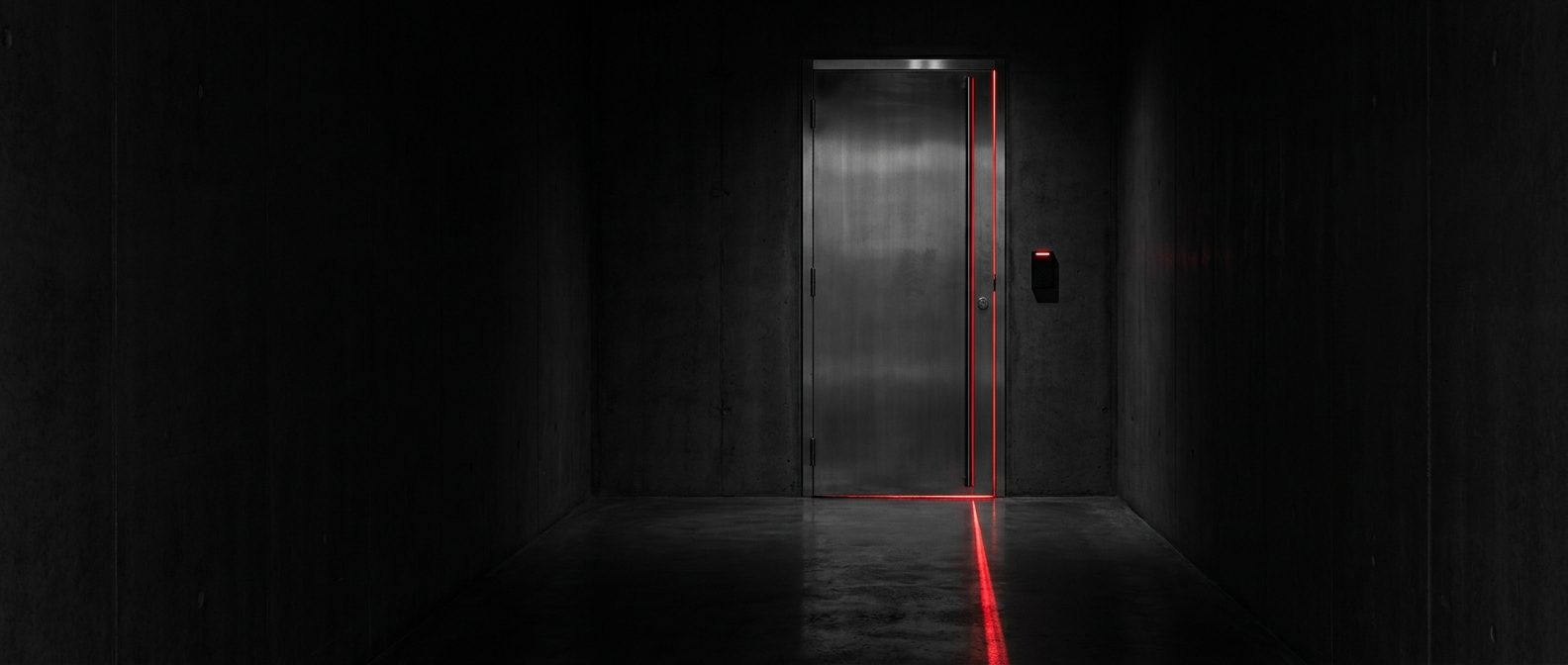 Secure data center door ajar with a line of red light